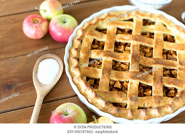 close up of apple pie on wooden table