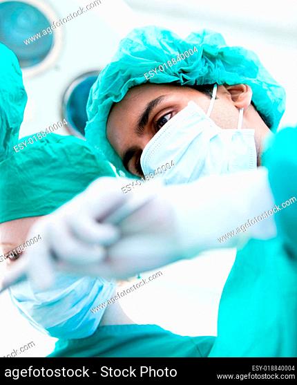 Serious surgeons during an operation. Medical concept