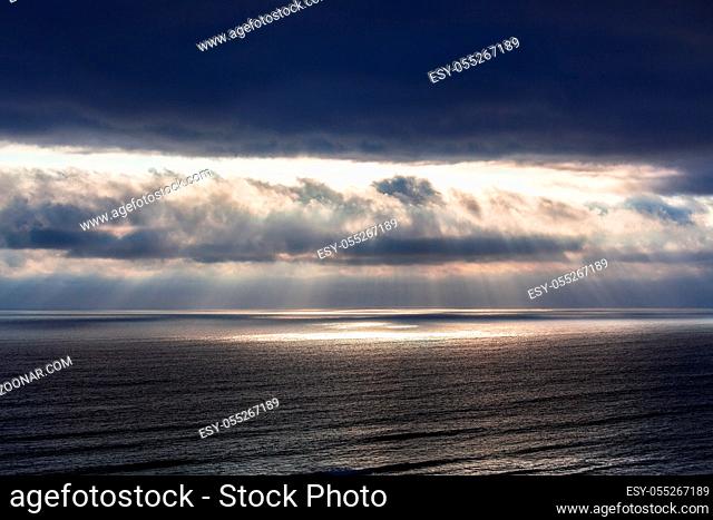 rays of sun through the clouds over the ocean