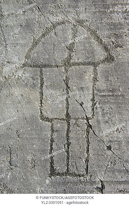 Petroglyph, rock carving, of a house on stilts. Carved by the ancient Camunni people in the iron age between 1000-1200 BC