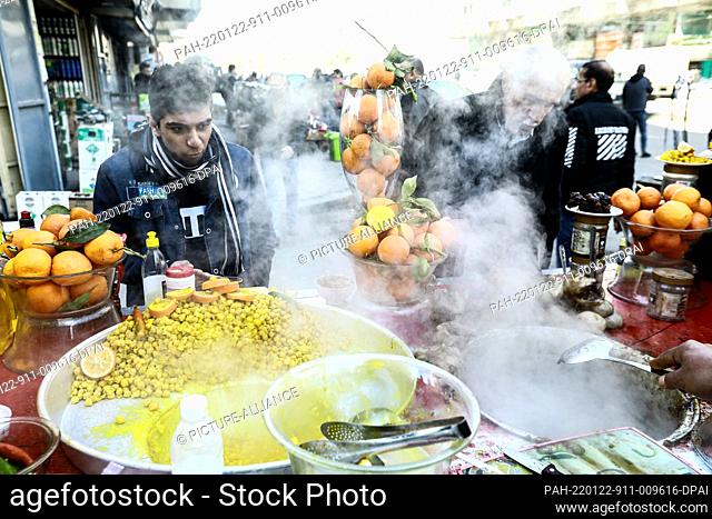 22 January 2022, Iraq, Baghdad: An Iraqi vendor prepares 'Lablabi', a traditional Iraqi winter street food made of chickpeas