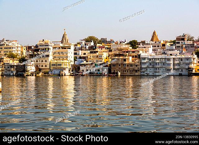 UDAIPUR, INDIA - NOVEMBER 23, 2012: Beautiful lake Pichola with buildings on the water