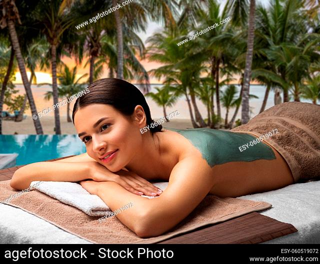 woman with blue clay mask in spa
