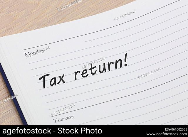 A tax return diary reminder open on desk
