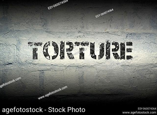 torture stencil print on the grunge white brick wall
