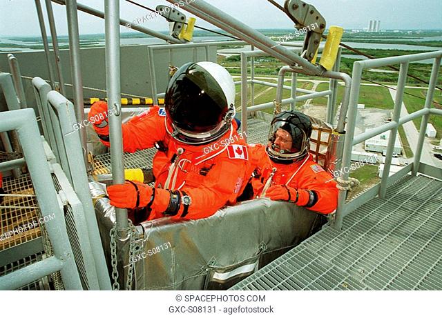 03/30/2001 -- STS-100 Mission Specialists Chris A. Hadfield left and John L. Phillips right settle in the slidewire basket at Launch Pad 39A