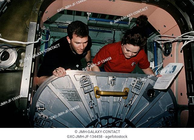 Astronauts Rick D. Husband and Tamara E. Jernigan adjust the hatch for the U.S.-built Unity node. The task was part of the overall effort by the seven-member...