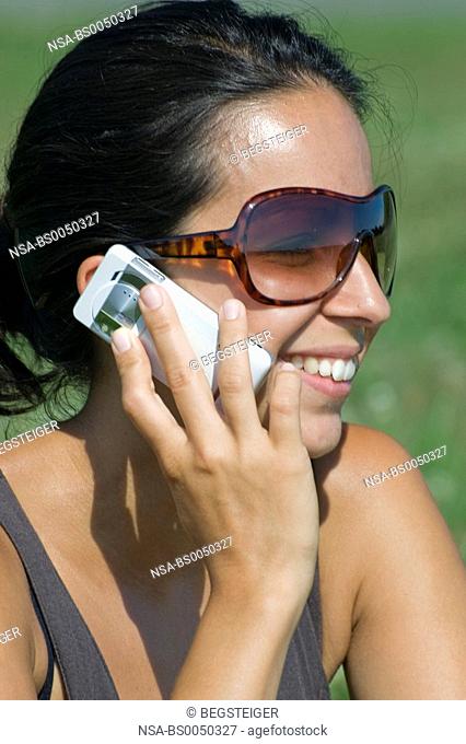 woman with mobile phone in meadow