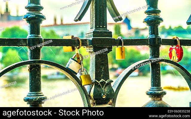 Love padlocks on fence of Charles Bridge in Prague