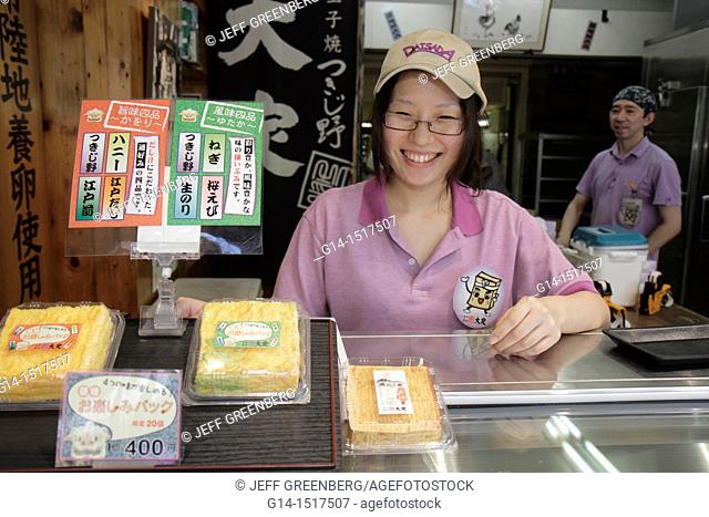 Japan, Tokyo, Tsukiji Fish Market, shopping, kanji, hiragana, characters, for sale, display, food vendor, Asian, woman, counter clerk, desserts
