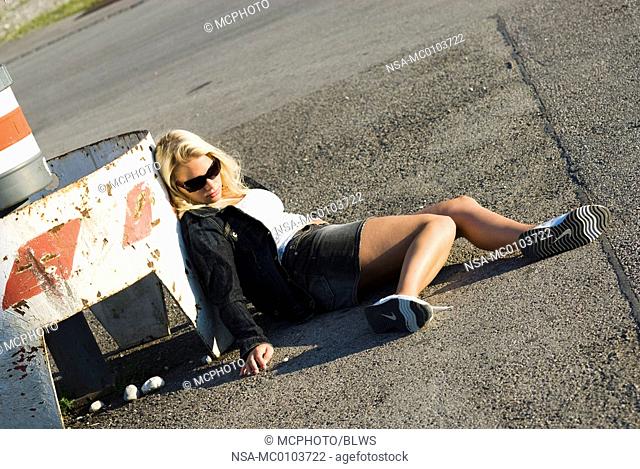 drug addicted women lying on the asphalt