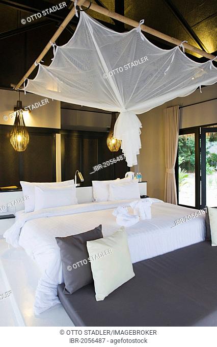 Bed with a mosquito net in a luxury bungalow, The Sevenseas Resort, Ko Kradan, Koh Kradan, Trang, Thailand, Southeast Asia, Asia