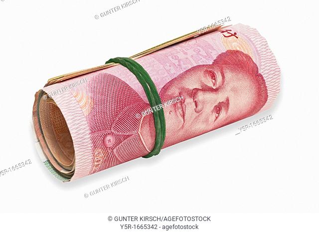 Many 100 Yuan bills, rolled up and held together with a rubber The renminbi, the Chinese currency, was introduced in 1949 after the founding of the People's...
