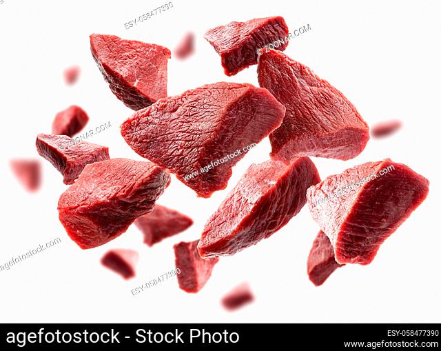 Pieces of fresh meat levitate on a white background