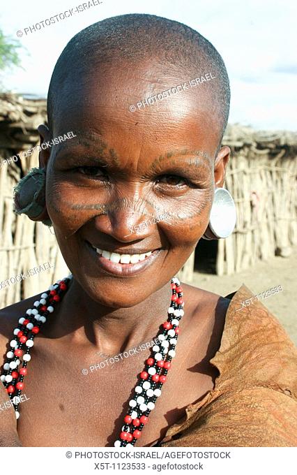 Africa, Tanzania, female members of the Datoga tribe Woman in traditional dress, beads and earrings  Beauty scarring can be seen around the eyes, April 2008