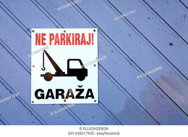 No parking area sign in slovenian language. Tow truck sign