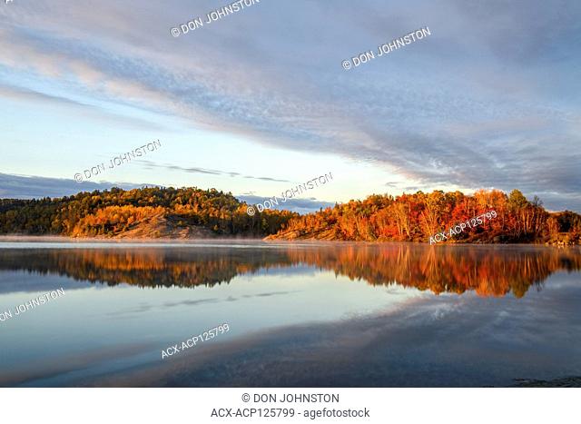 Autumn reflections in Simon Lake at dawn, Greater Sudbury, Ontario, Canada