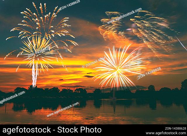 Fireworks display on majestic beautiful sky sunset lake