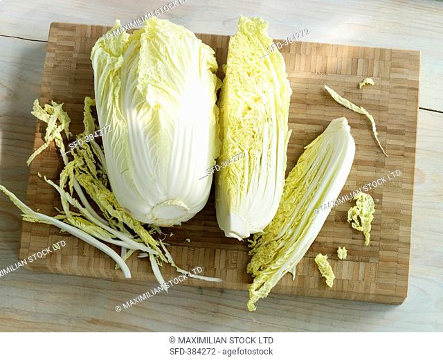 Chinese cabbage on a wooden board, whole and quartered