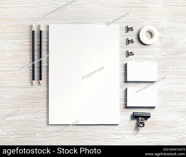 Blank white stationery set. Business brand template on light wooden background. Top view. Flat lay