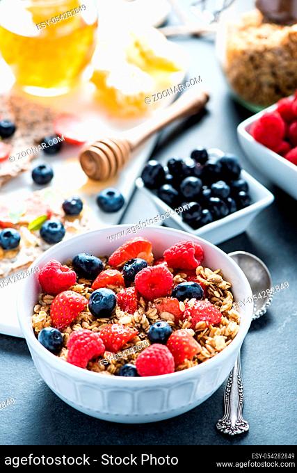 Bowl with granole and berries, healthy breakfast concept