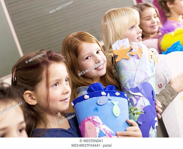 Pupils holding schoolcone