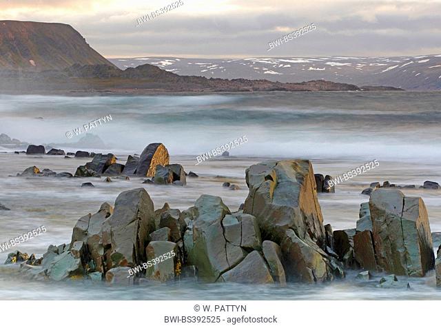 stormy coastline and snowy peaks, fjells along coast, Barentz sea, Norway, Varangerfjord