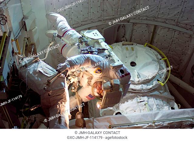 Astronaut Mike Foreman, STS-129 mission specialist, participates in the mission's first session of extravehicular activity (EVA) as construction and maintenance...