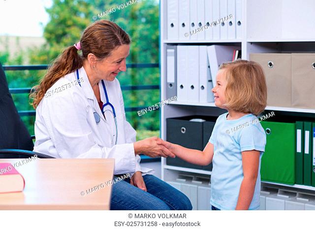 female pediatrician in white lab coat and the little patient