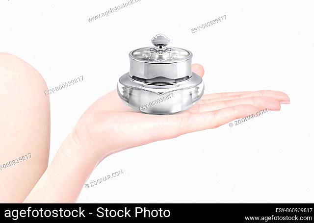Silver deluxe cosmetic jar on hand isolated