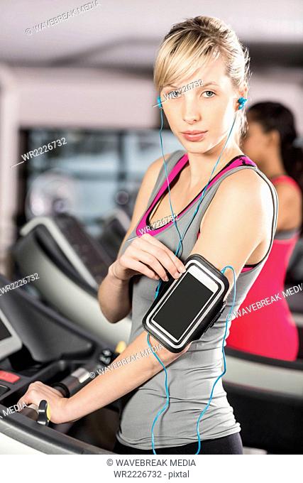 Fit woman on treadmill with headphones