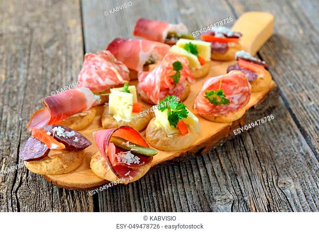 South Tyrolean appetizers: Local crunchy rye bread with smoked bacon, hearty wine cheese and Italian salami