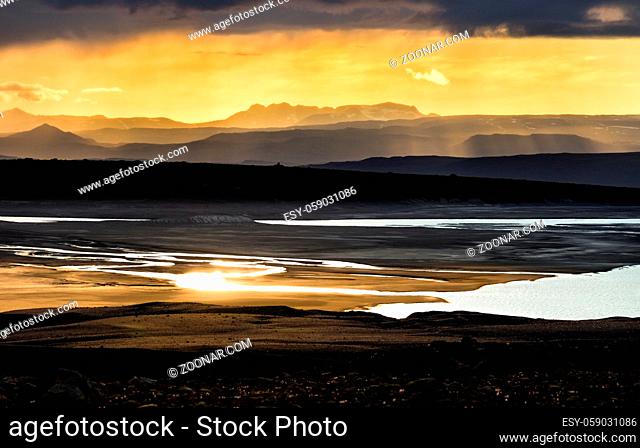 Colorful sunlight sunset over the mountains, river and lake. Amazing view of the landscape in Iceland