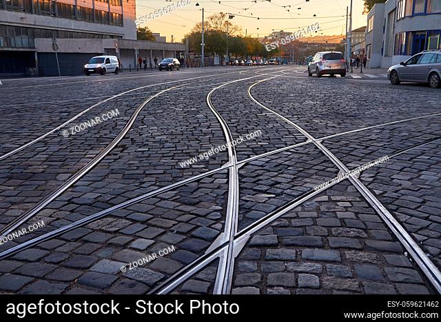 Tram rails rails through a cobblestone street