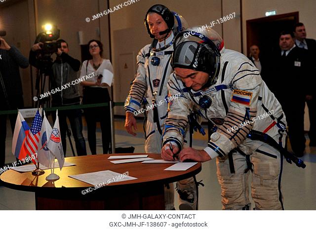 At the Gagarin Cosmonaut Training Center in Star City, Russia, Expedition 3940 Soyuz Commander Alexander Skvortsov of Roscosmos (right) signs in for final...