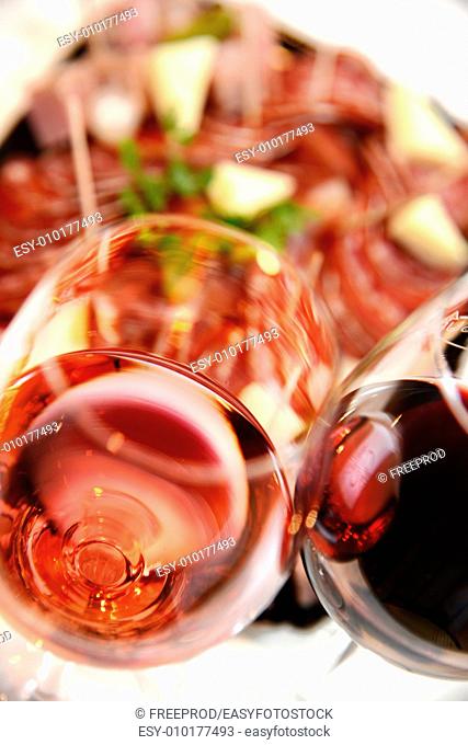 Red and Pink glass of wine with delicatessen