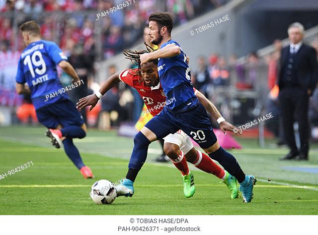 Bayern's Renato Sanches (L) and Darmastadt's Marcel Heller fight for the ball during the German Bundesliga soccer match between Bayern Munich and Darmstadt 98...