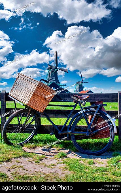 Bicycle with windmill and blue sky background. Scenic countryside landscape close to Amsterdam in Netherlands