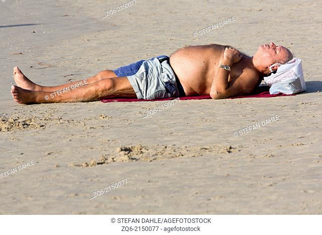Taking a Sunbath on Patong Beach, Phuket, Thailand