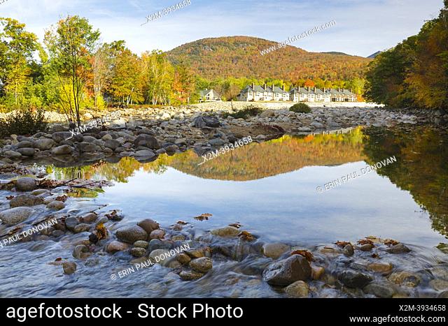 Autumn foliage on Little Coolidge Mountain from along the East Branch of the Pemigewasset River in Lincoln, New Hampshire on an autumn October day