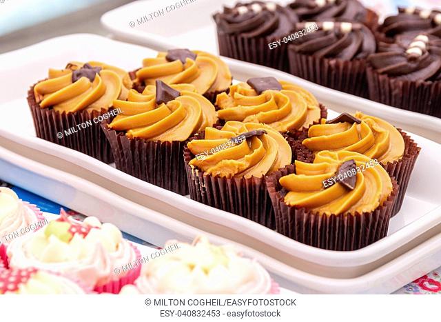 Homemade orange and chocolate cupcakes on a market stall
