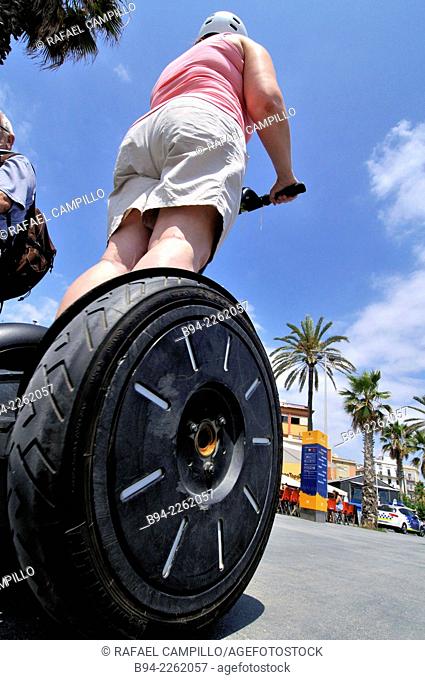 Woman on Segway Two-wheeled electric vehicle, invented by Dean Kamen and introduced the year 2001. Barcelona. Catalonia. Spain