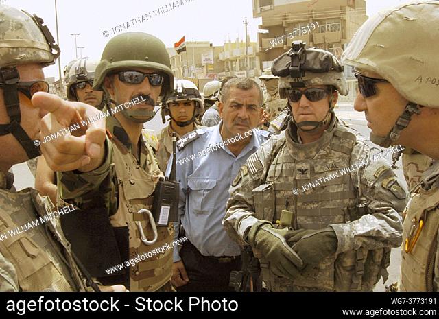 IRAQ Baghdad -- 20 Aug 2006 -- US Army Colonel Thomas Vail (second from right), an Iraqi police officer and the commanding officer of the 6th Iraqi Army...