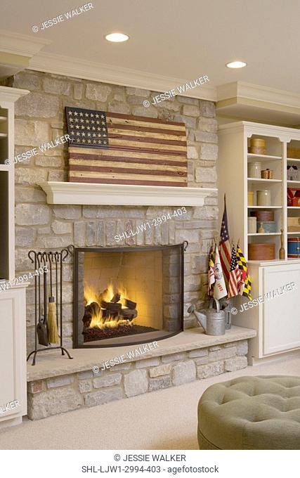 FIREPLACES: contemporary country, stone fireplace, suspended mantel, wooden american flag, book shelves on either side, ottoman, flags in a watering can