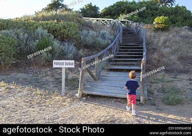 Little boy visit Dunes park of Matalascanas. Costa de la Luz seashore, Huelva, Spain