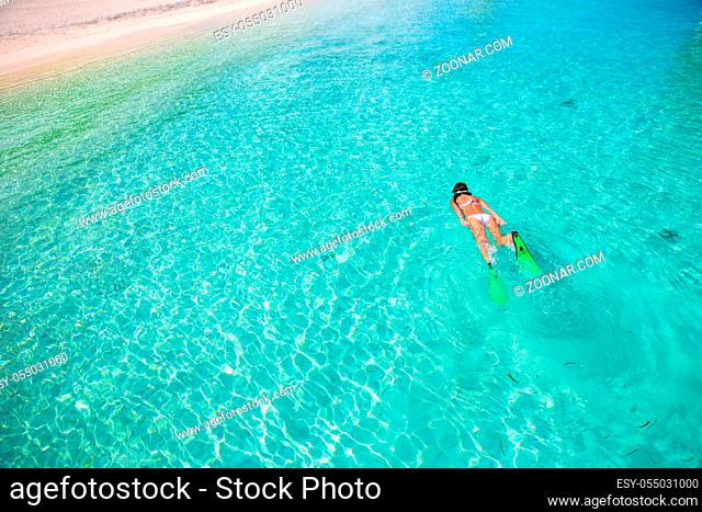 Woman snorkeling in tropical water on vacation