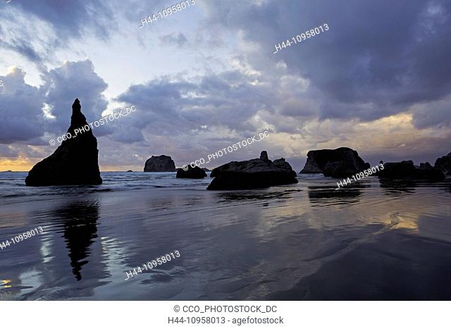 Tidepools and sea stacks, rocks, at sunset along Bandon Beach, Oregon. Winter. USA