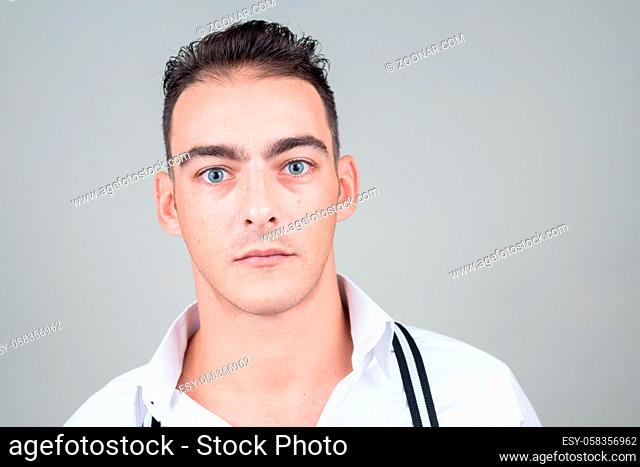 Studio shot of young handsome businessman against white background
