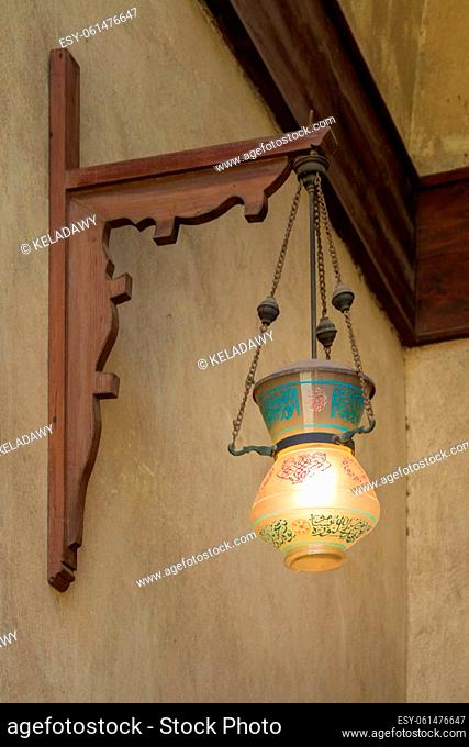 Vintage Arabic glass street lantern hanged on a wooden pole, Dome of Sultan Al Nassir Qalawun, Cairo, Egypt