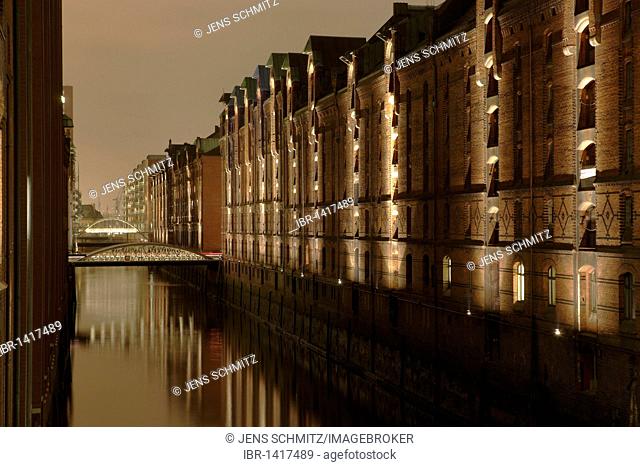 Speicherstadt historical warehouse district at night, in front the Brookfleet canal, Kehrwiederfleet canal in the back, warehouses left and right, Hamburg
